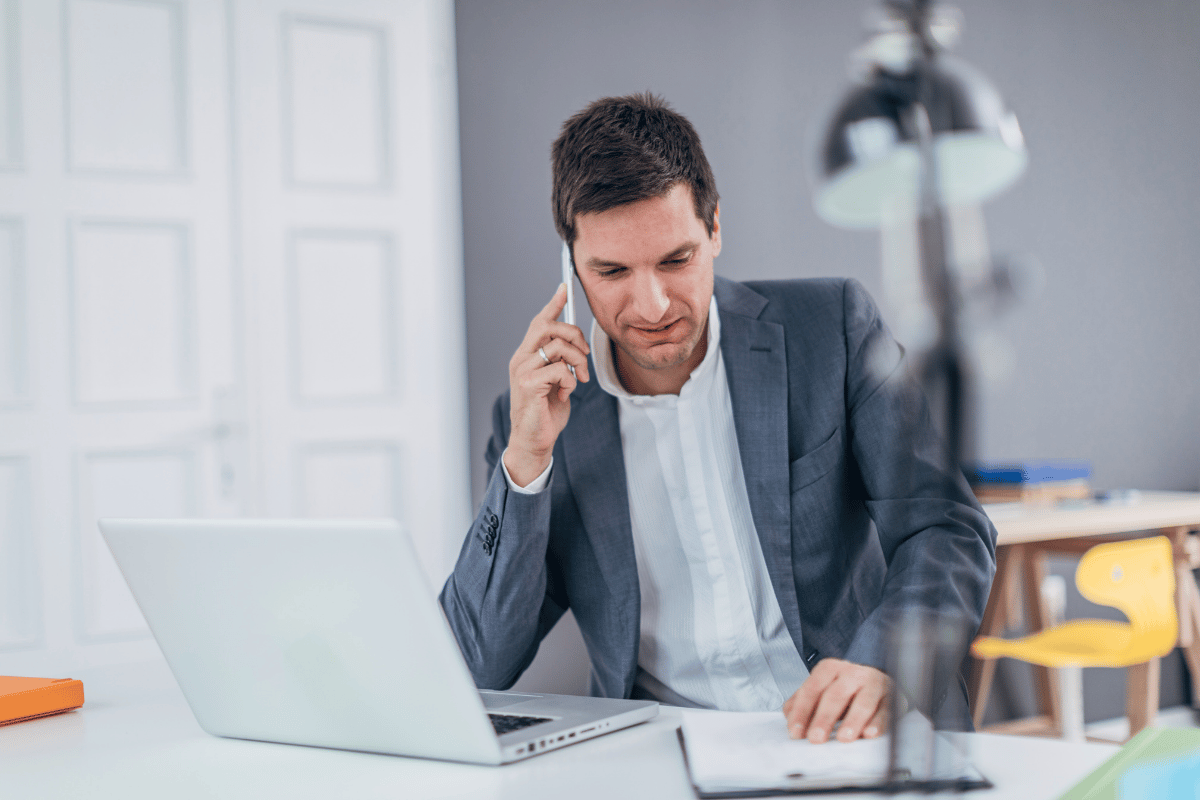Business VoIP call on desk phone, laptop, and mobile device for flexible calling options.