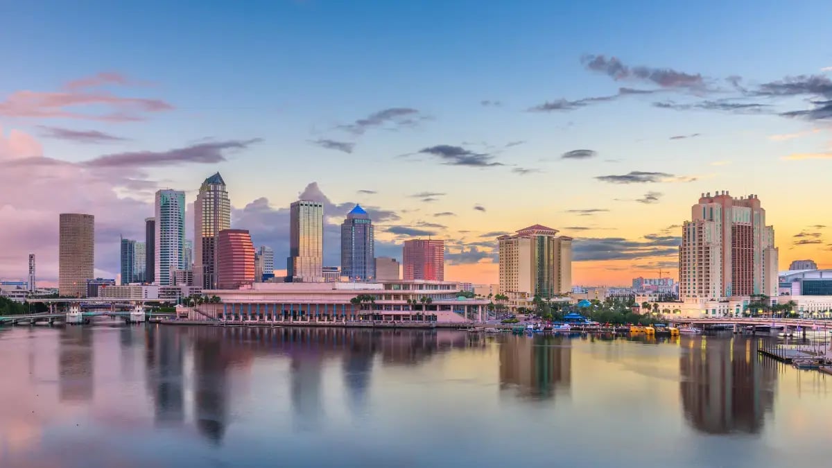 Downtown Tampa skyline at sunset, reflected over the Hillsborough River in Florida.